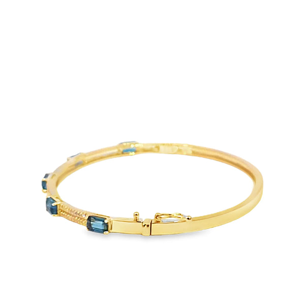 Brazalete en oro amarillo de 14K con diamante de 0.24CT y topacio azul
