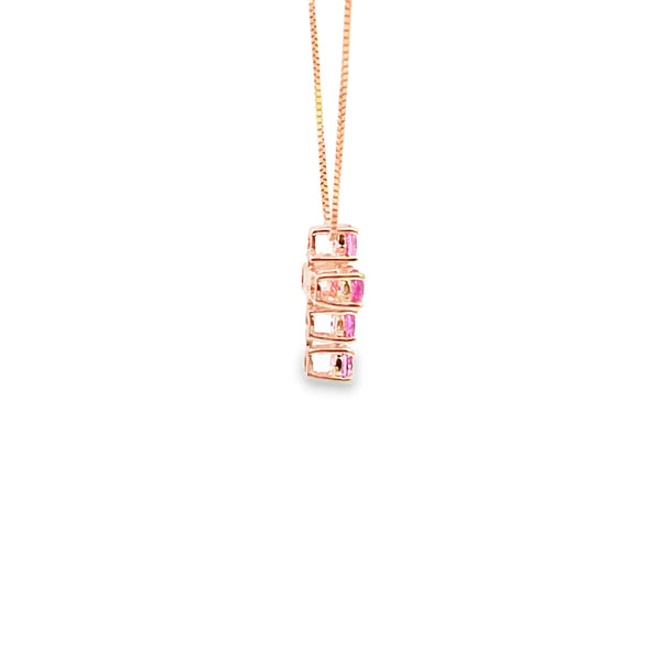 Cruz con cadena en oro de 14K con diamante de 0.76 ct y zafiro rosa