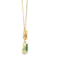 Dije con cadena bicolor en oro de 14K con diamante de 0.11 ct, esmeralda de 0.34 ct
